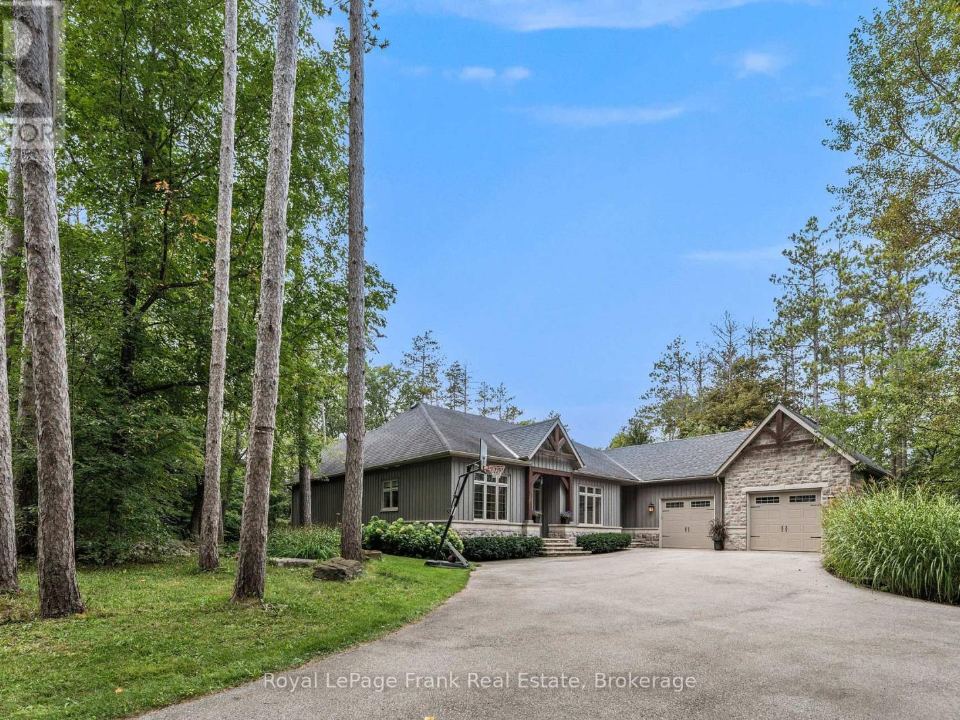 Stone and wood bungalow at 860 Brookdale Road set among tall trees
