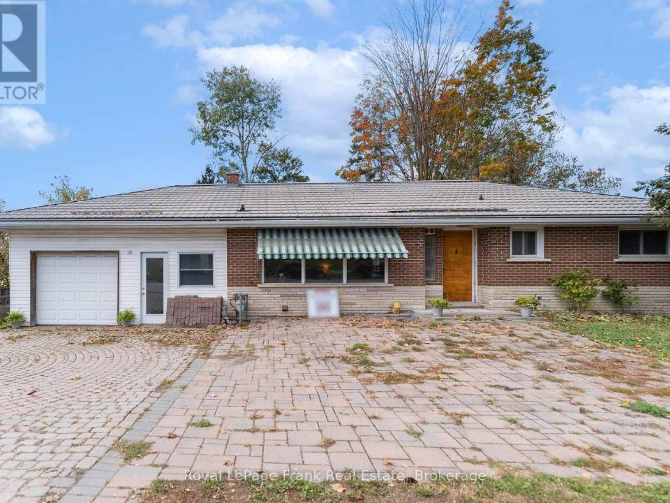 Brick bungalow at 32 Main Street North with a striped awning